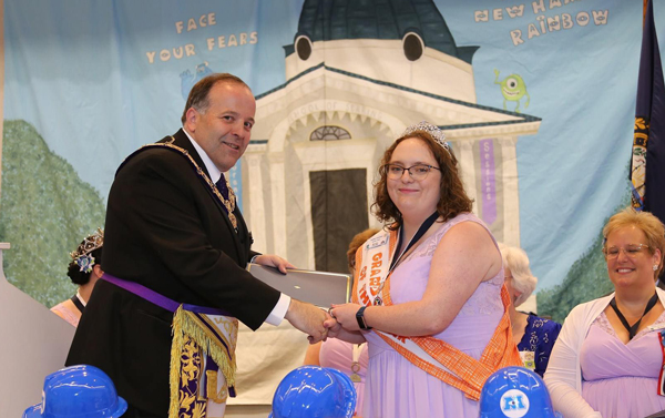 Rainbow girl receiving Grand Lodge scholarship at Grand Assembly